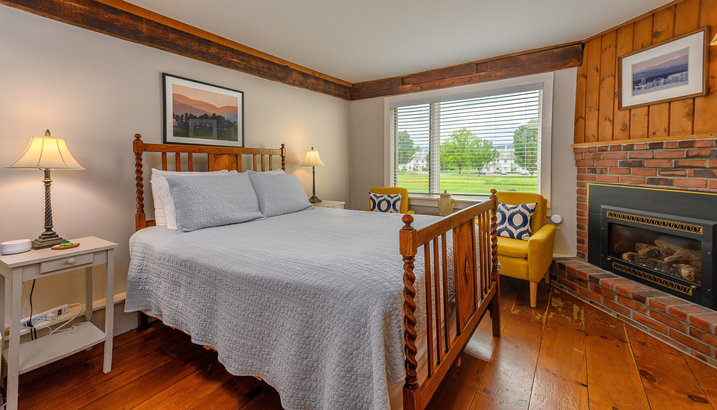 full bed and fireplace in room at brass lantern inn