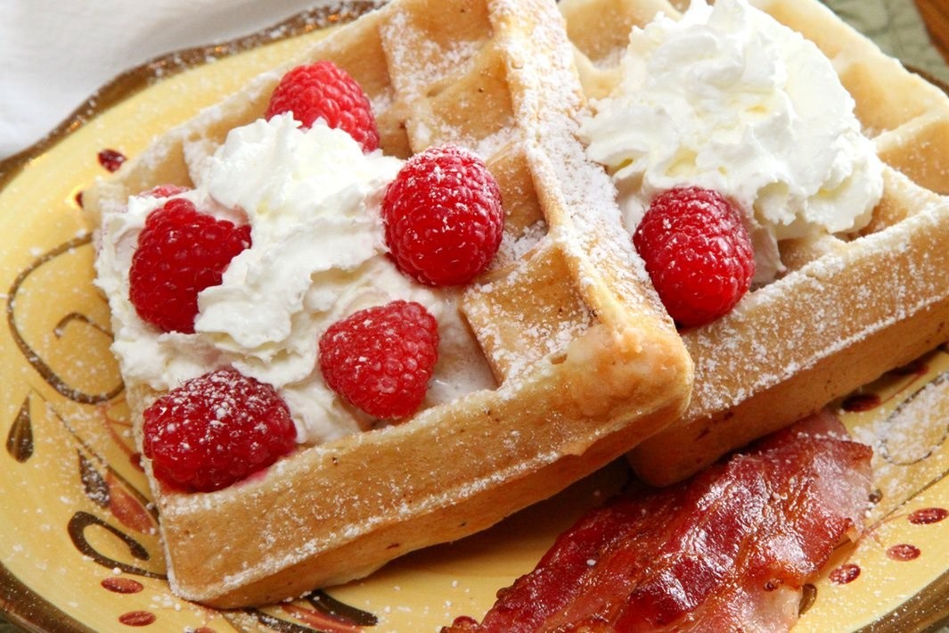 delicious waffle with vermont maple syrup and fresh raspberries